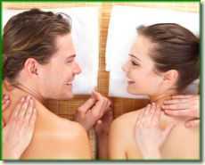 Close up portrait of a romantic couple, on a spa holiday, having a back massage